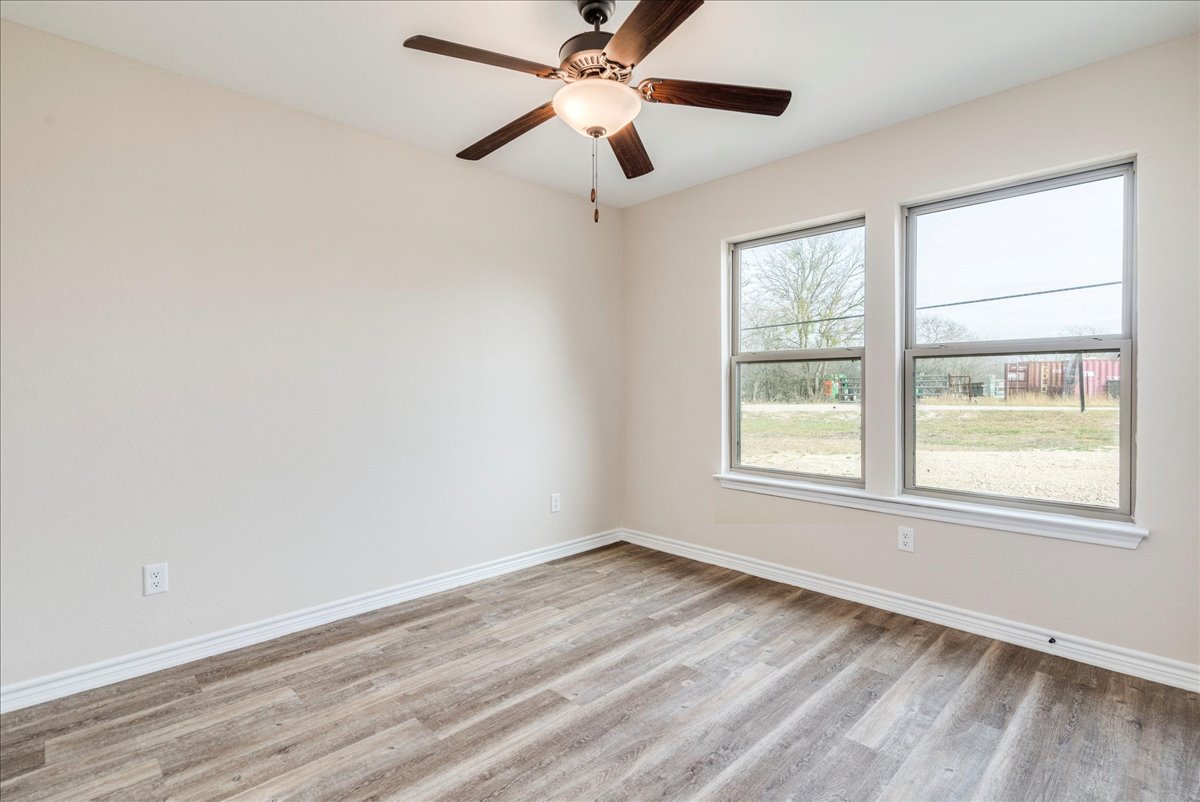 1092 Engelke Road Niederwald, TX 78640 - Photo 15 of 24 a view of an empty room with wooden floor and a window