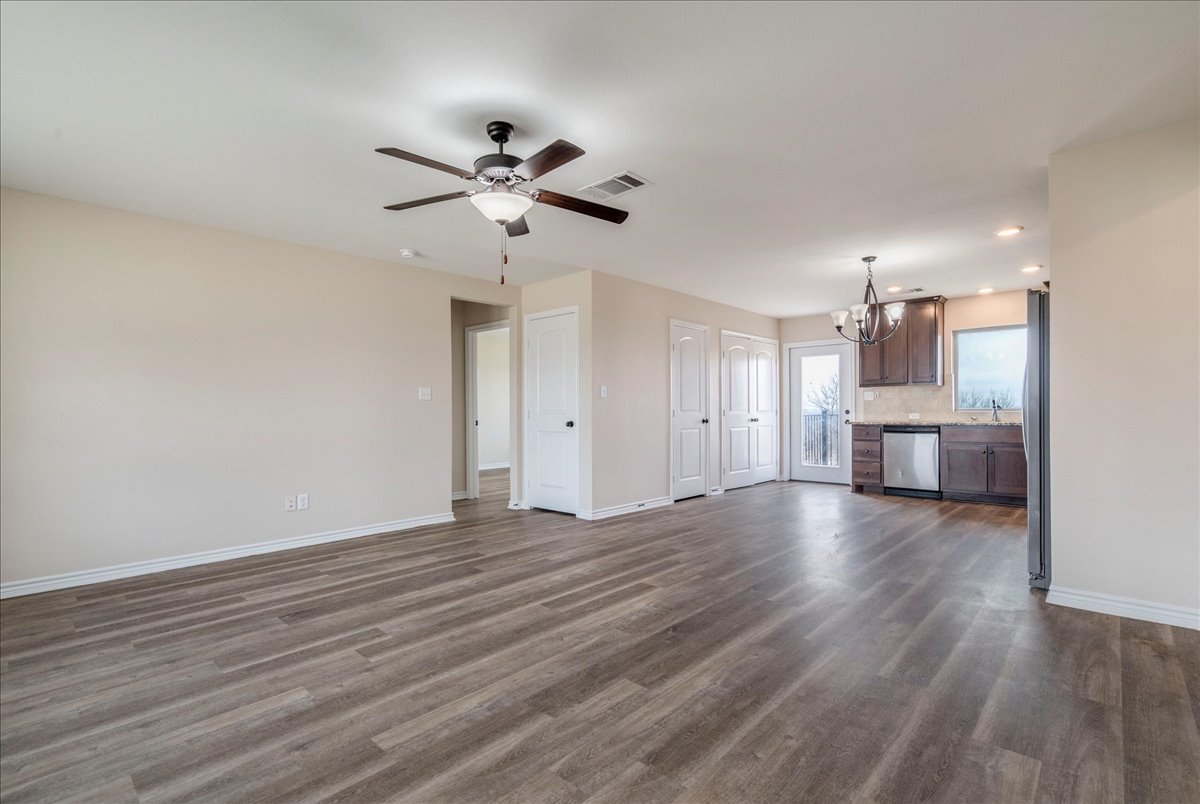 1092 Engelke Road Niederwald, TX 78640 - Photo 4 of 24 a view of a kitchen with wooden floor and a ceiling fan