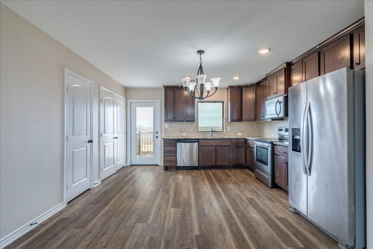 1092 Engelke Road Niederwald, TX 78640 - Photo 8 of 24 a white kitchen with a sink and stainless steel appliances
