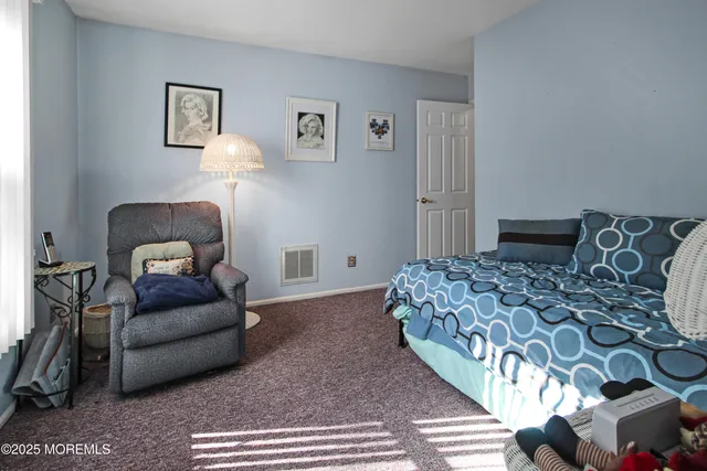 a bedroom with a bed and a couch