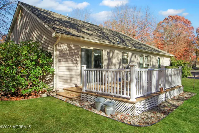 a view of a house with a small yard and wooden fence