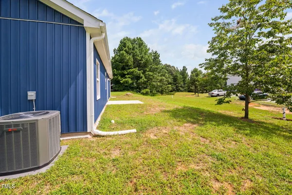 a view of a house with a yard and garage