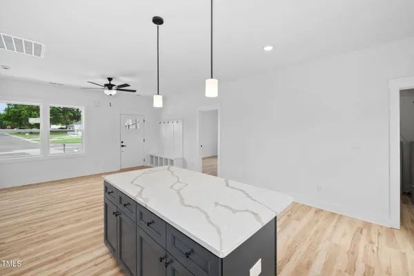 a kitchen with a stove sink and white cabinets