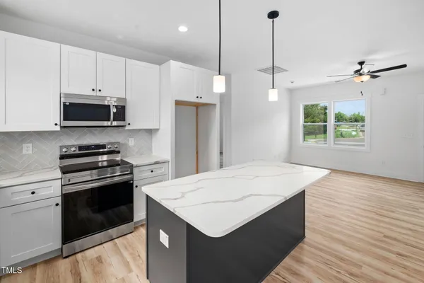a view of a kitchen with a sink and wooden floor