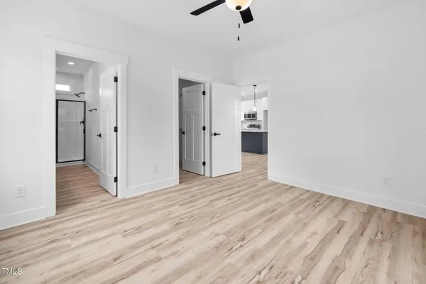wooden floor in an empty room with a window