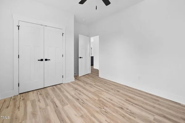 a view of an empty room with wooden floor