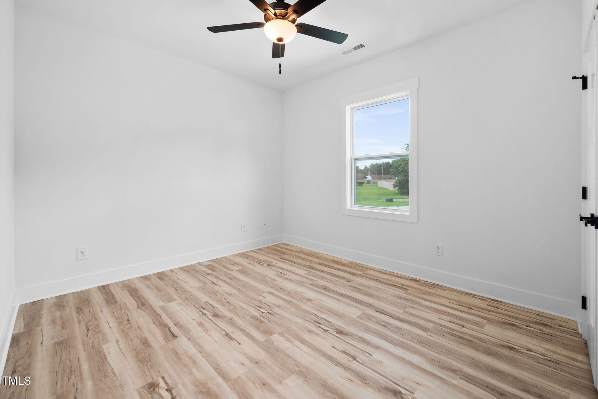 50 Southern Village Drive Roxboro, NC 27573 - Photo 31 of 32 wooden floor in an empty room with a window