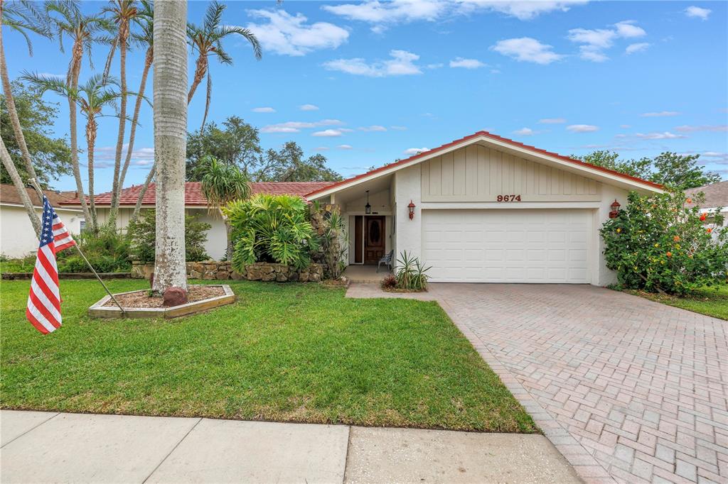 9674 104th Avenue Largo, FL 33773 - Photo 1 of 1 a view of a house with a yard potted plants and a large tree