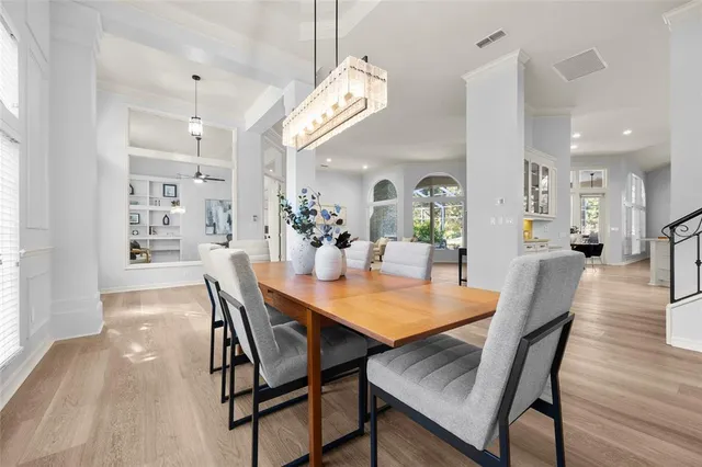 a kitchen with a refrigerator a sink dishwasher a stove and white cabinets with wooden floor