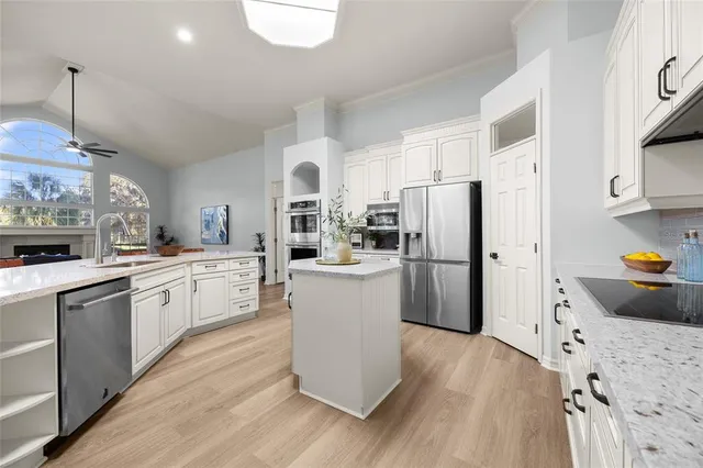 a large white kitchen with cabinets