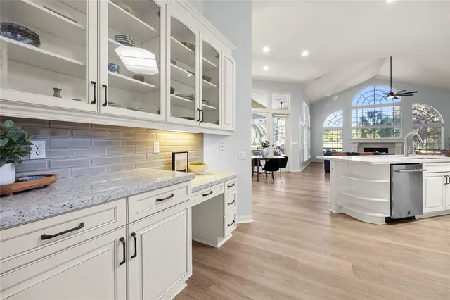 a living room with furniture large window and a fireplace