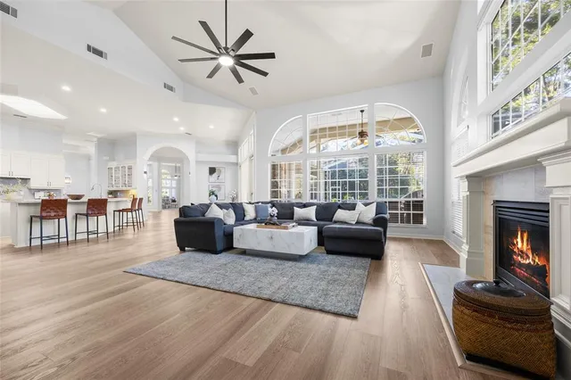 a living room with furniture a large window and a fireplace