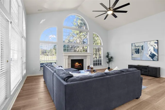 a bedroom with a bed wooden floor and window