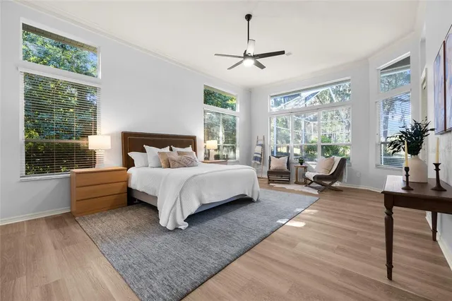 a spacious bathroom with a double vanity sink a large mirror a bathtub and window