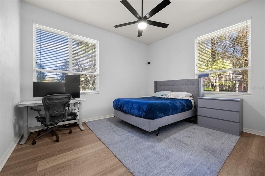 4606 Southwest 97th Terrace Gainesville, FL 32608 - Photo 42 of 68 a bedroom with a bed and a desk