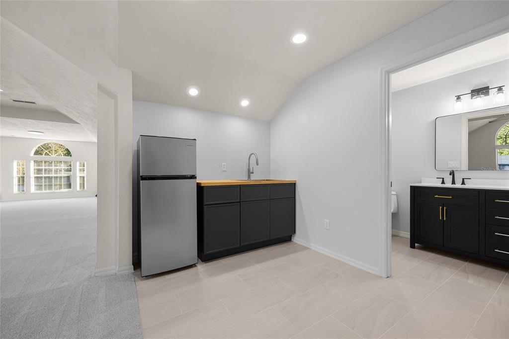 4606 Southwest 97th Terrace Gainesville, FL 32608 - Photo 44 of 68 a kitchen with a refrigerator sink and cabinets