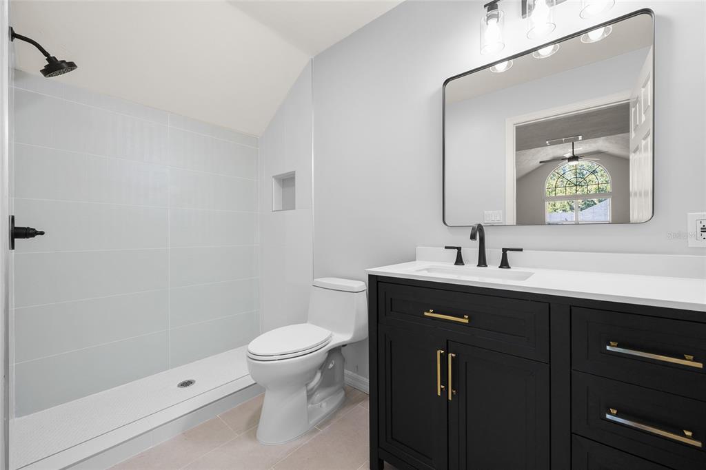 4606 Southwest 97th Terrace Gainesville, FL 32608 - Photo 45 of 68 a bathroom with a sink a toilet and mirror