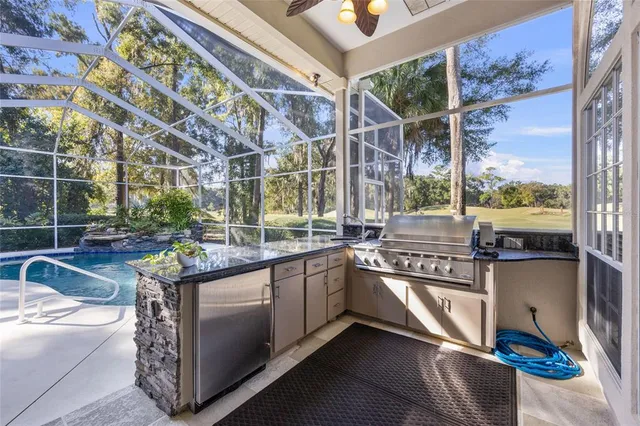 an aerial view of residential houses with outdoor space and trees all around