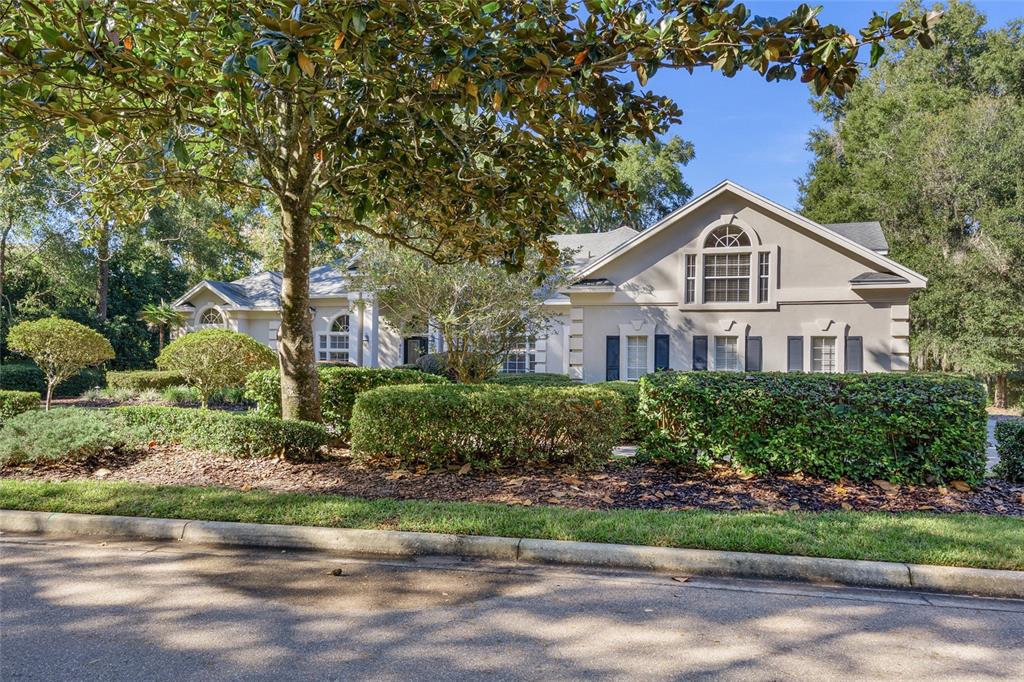 4606 Southwest 97th Terrace Gainesville, FL 32608 - Photo 5 of 68 a front view of a house with a garden