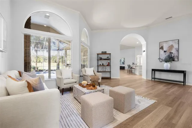 a living room with furniture and large windows