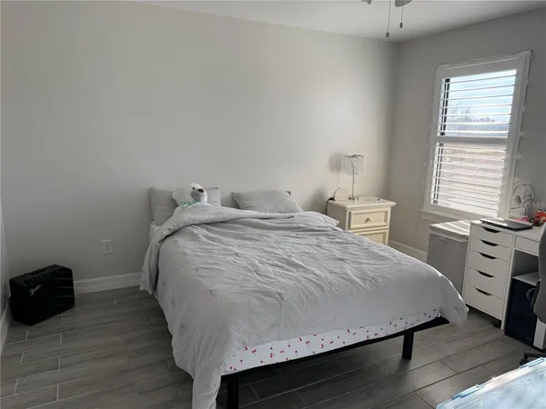 a bedroom with a bed and a lamp