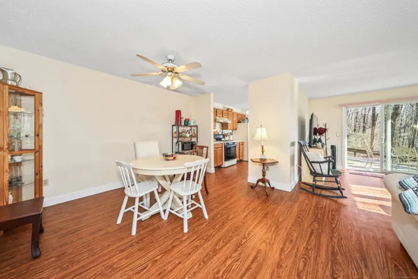 a view of a dining room with furniture wooden floor and chandelier