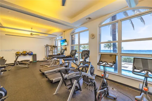 a room with gym equipment and large mirror
