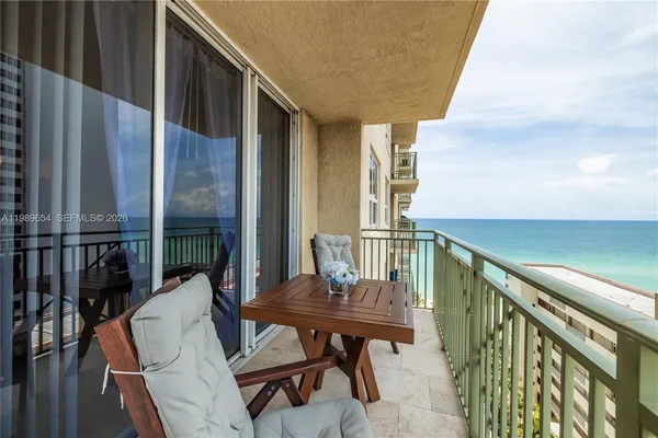 a view of balcony with wooden floor and outdoor seating
