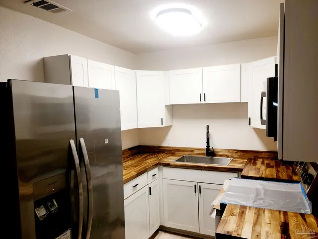 a kitchen with a refrigerator and a stove