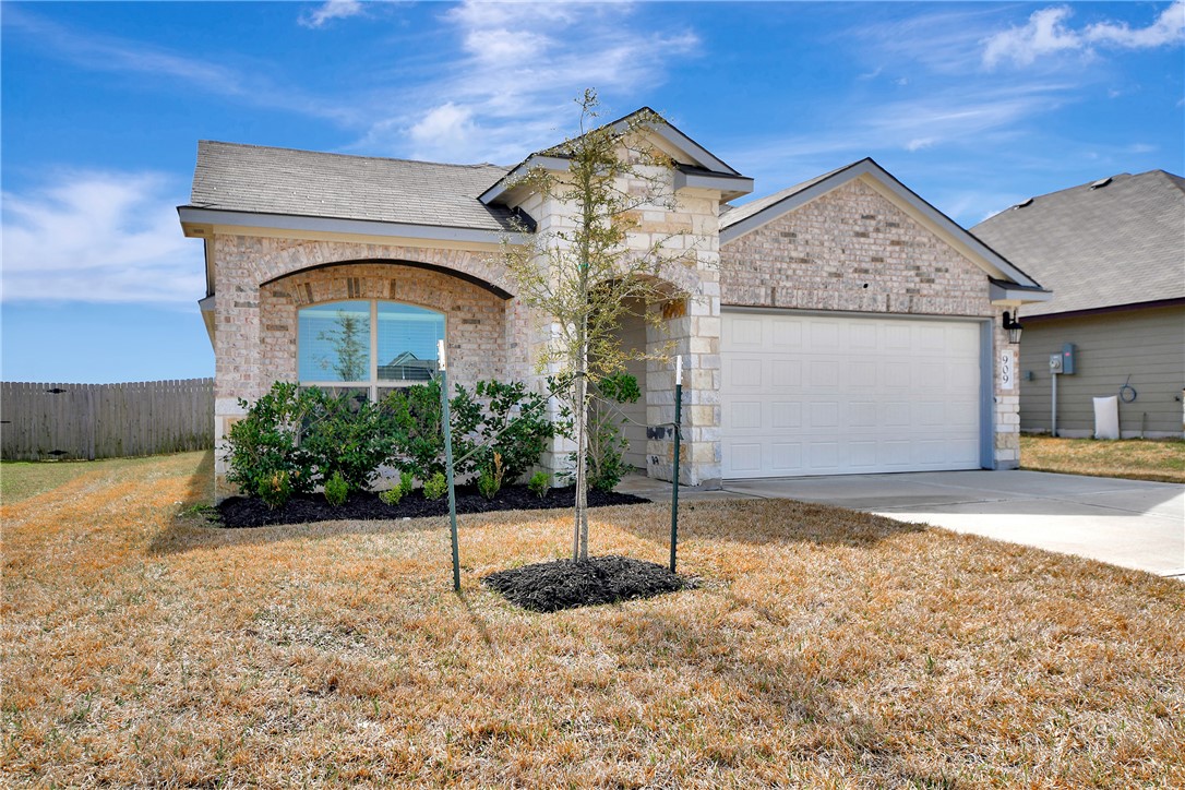 909 Davy Street Brenham, TX 77833 - Photo 1 of 35 Home featuring brick siding, an attached garage, and concrete driveway