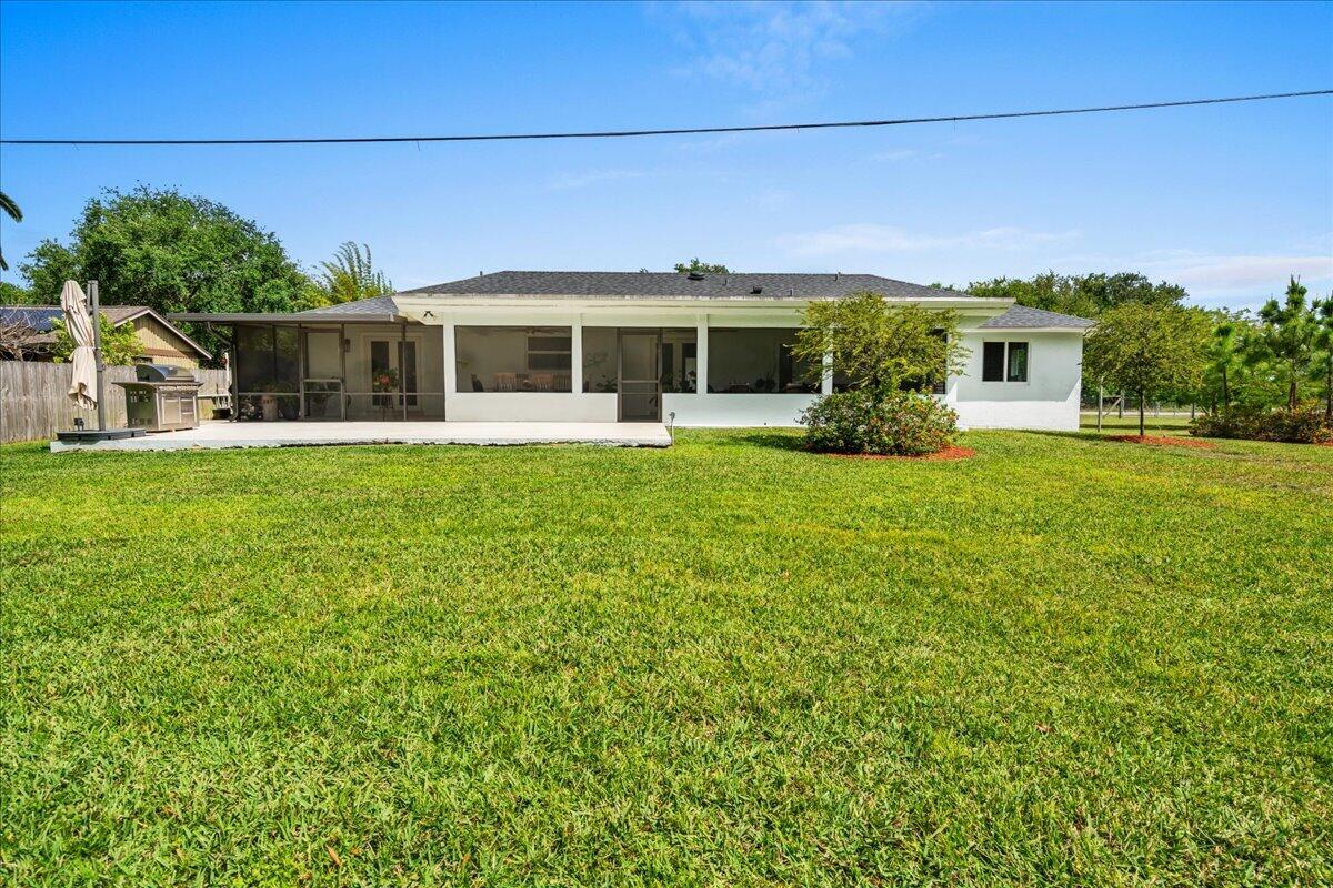 19724 Southwest 243rd Terrace Homestead, FL 33031 - Photo 27 of 49 a front view of a house with a garden