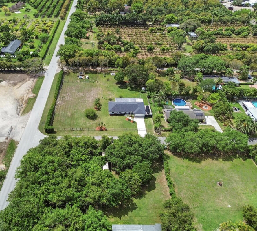 19724 Southwest 243rd Terrace Homestead, FL 33031 - Photo 39 of 49 an aerial view of residential houses with outdoor space and trees all around