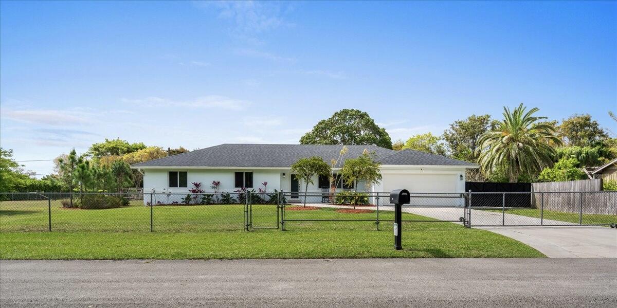 19724 Southwest 243rd Terrace Homestead, FL 33031 - Photo 47 of 49 a front view of a house with a yard