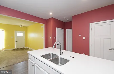 a kitchen with stainless steel appliances granite countertop a sink and stove top oven