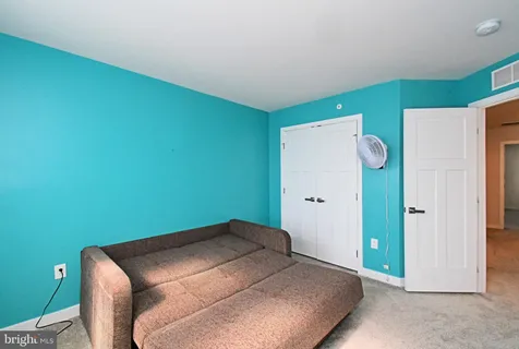 a bedroom with a bed and glass window