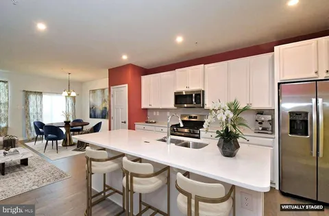 a kitchen with a sink a stove and cabinets