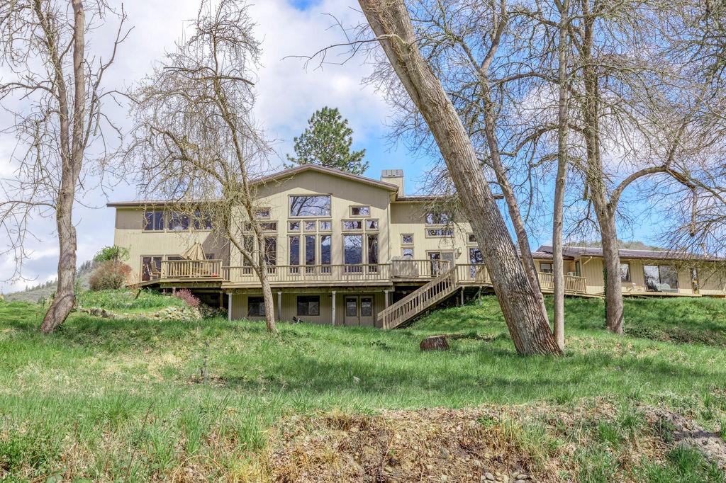 2076 Upper Applegate Road Jacksonville, OR 97530 - Photo 3 of 35 a view of a house with a big yard and large trees