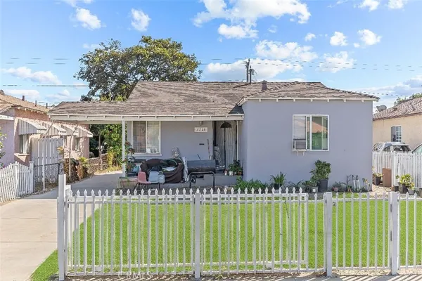 a front view of house with a garden and patio