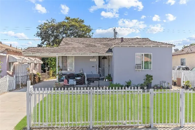 a front view of house with a garden and patio