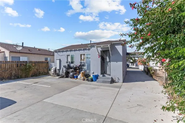 a view of a house with sitting area and garden