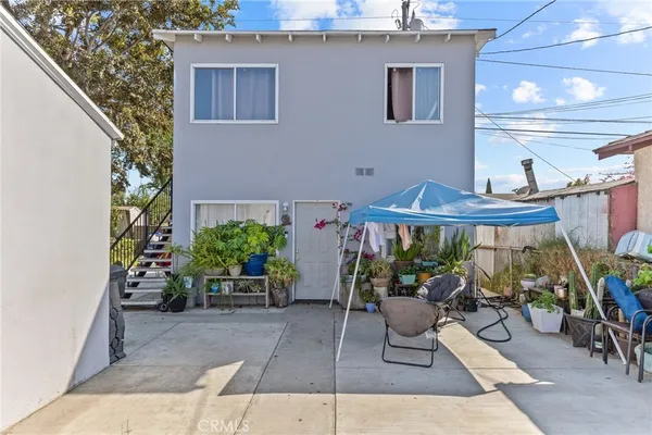 a view of a patio with table and chairs potted plants