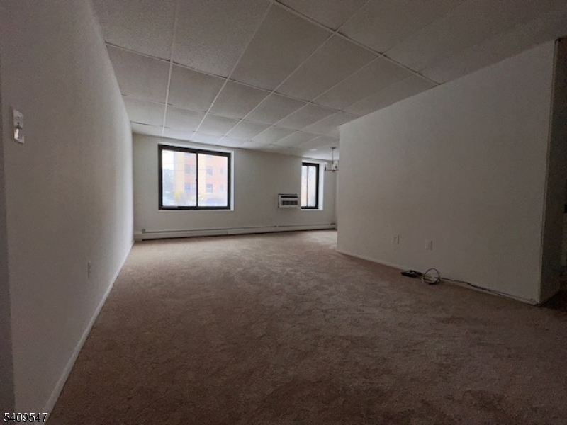 77 Prospect Avenue, Unit A Hackensack, NJ 07601 - Photo 11 of 16 an empty room with windows