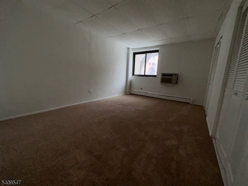 77 Prospect Avenue, Unit A Hackensack, NJ 07601 - Photo 12 of 16 a view of empty room with windows