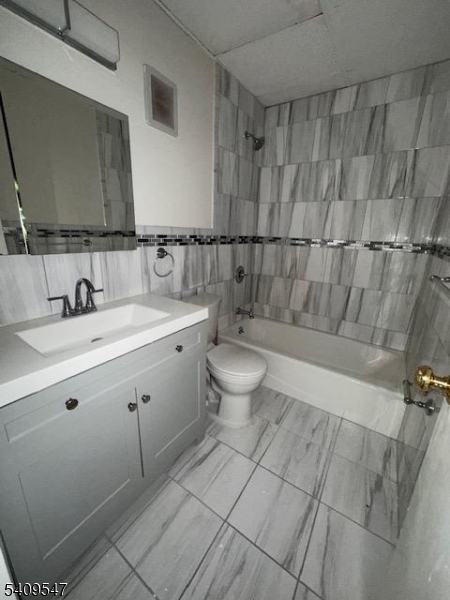 77 Prospect Avenue, Unit A Hackensack, NJ 07601 - Photo 7 of 16 a bathroom with a sink a toilet and shower
