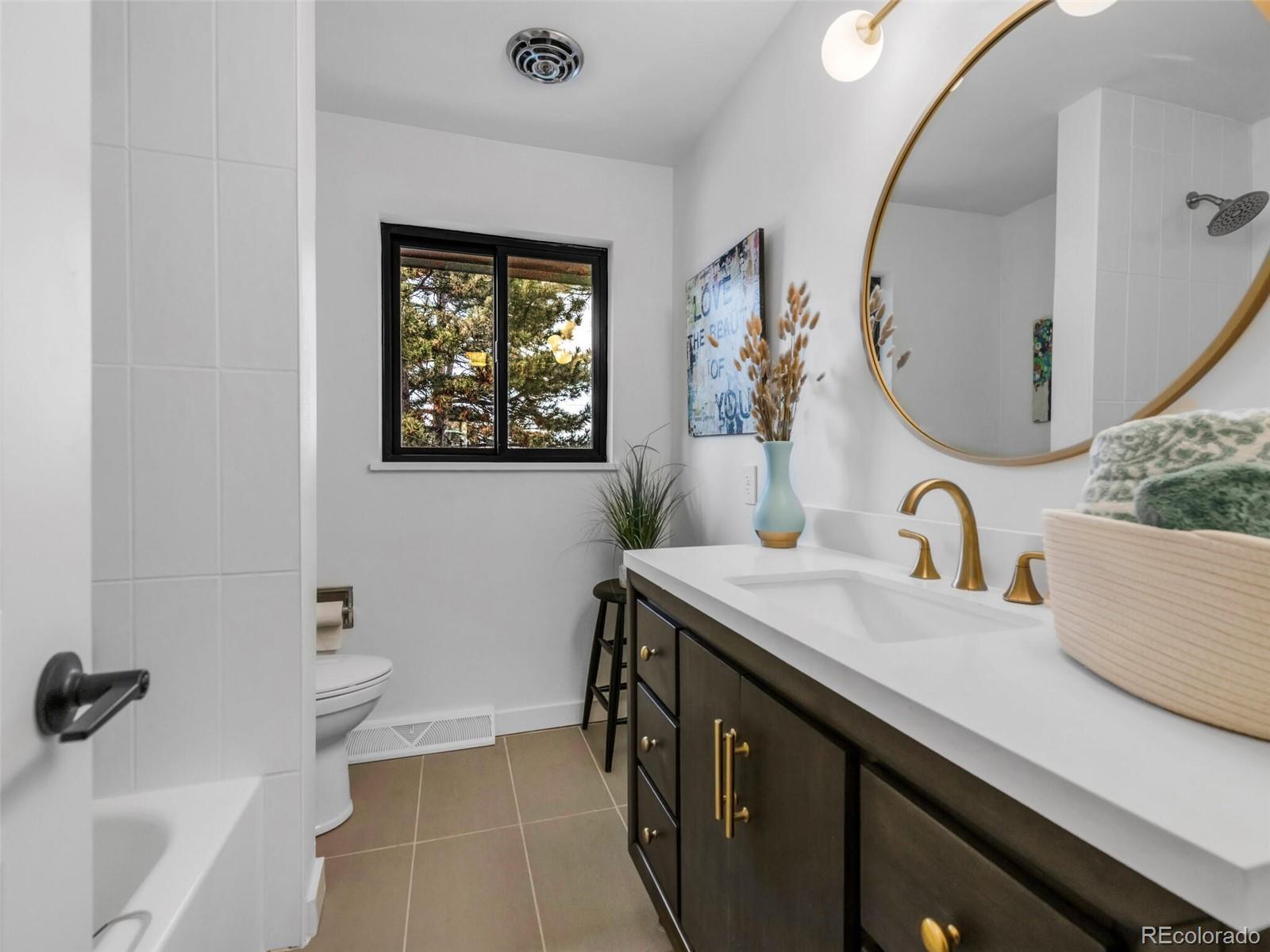 1345 Overhill Road Golden, CO 80401 - Photo 15 of 40 a bathroom with a sink and a mirror