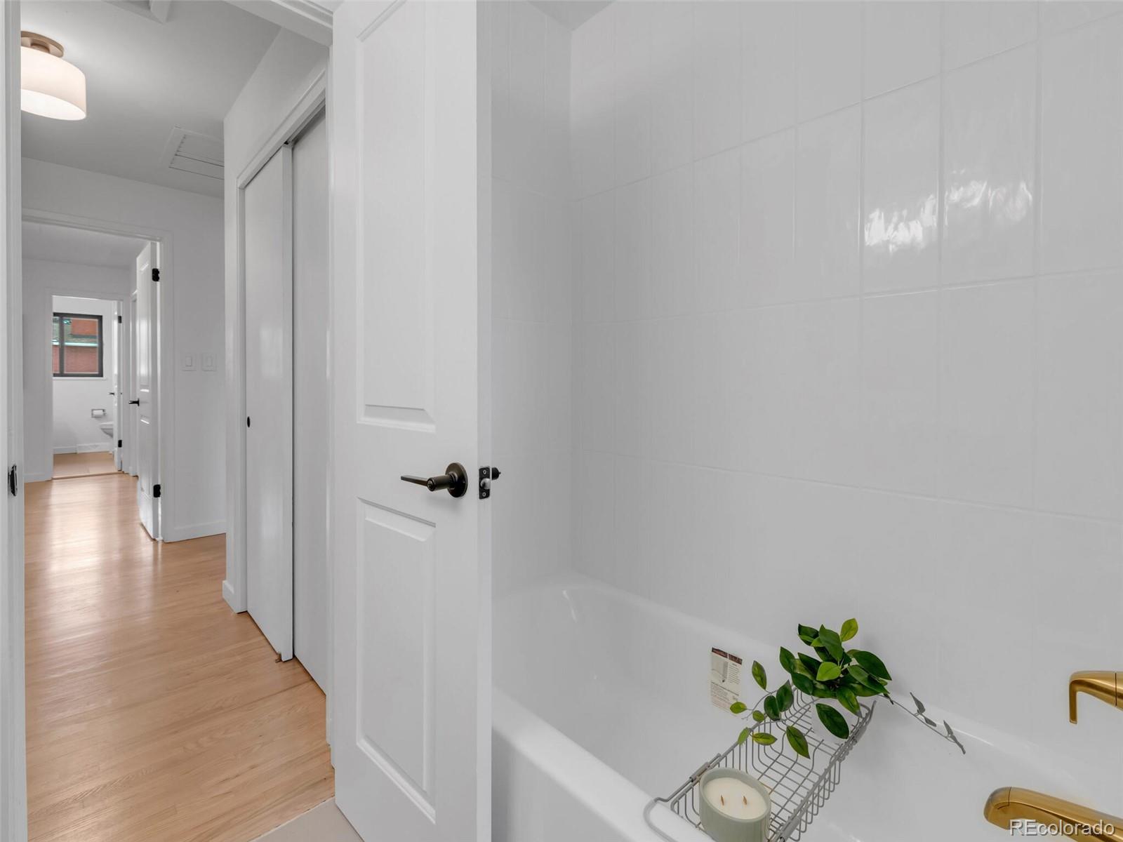 1345 Overhill Road Golden, CO 80401 - Photo 16 of 40 a view of a hallway with wooden floor and cabinet