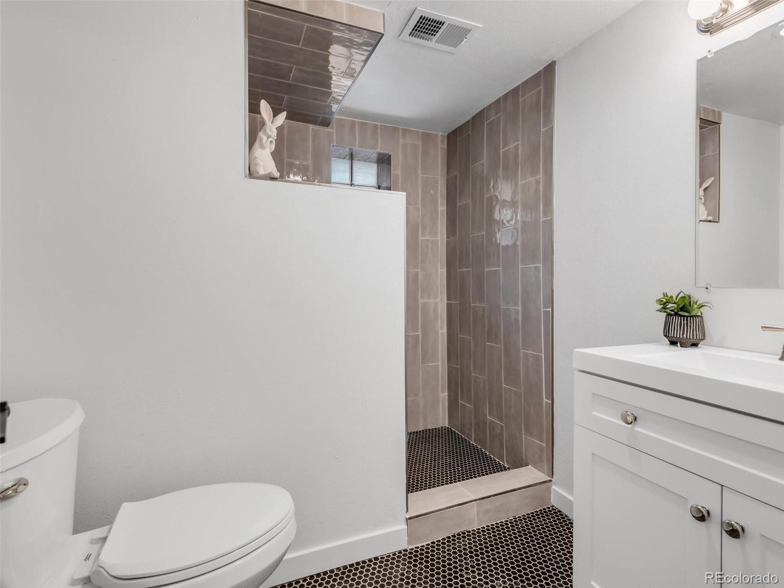 1345 Overhill Road Golden, CO 80401 - Photo 23 of 40 a bathroom with a shower a toilet and a sink