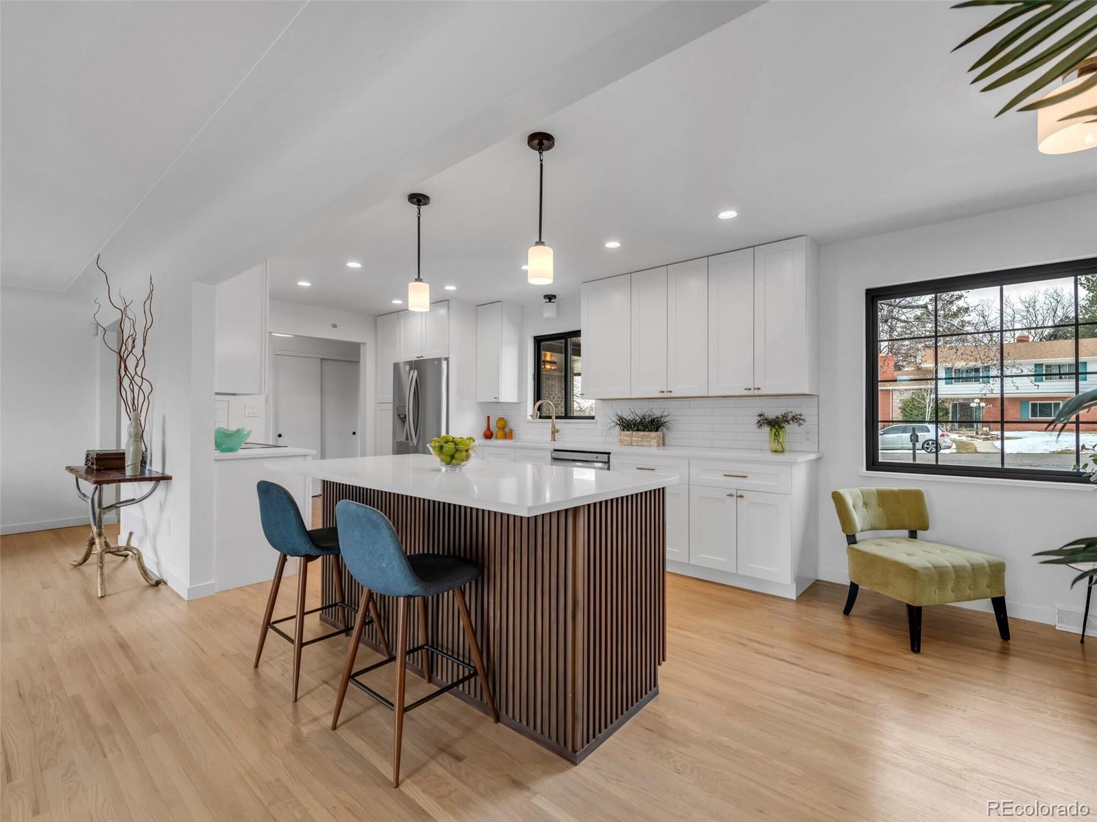 1345 Overhill Road Golden, CO 80401 - Photo 3 of 40 a kitchen with a dining table chairs sink and cabinets