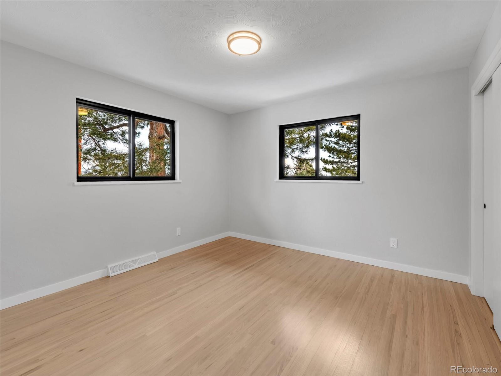 1345 Overhill Road Golden, CO 80401 - Photo 33 of 40 a view of an empty room with wooden floor and window