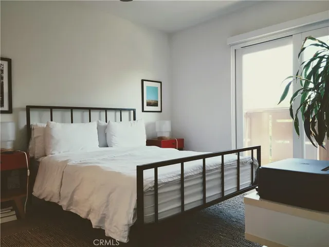 a bed sitting in a bedroom next to a window